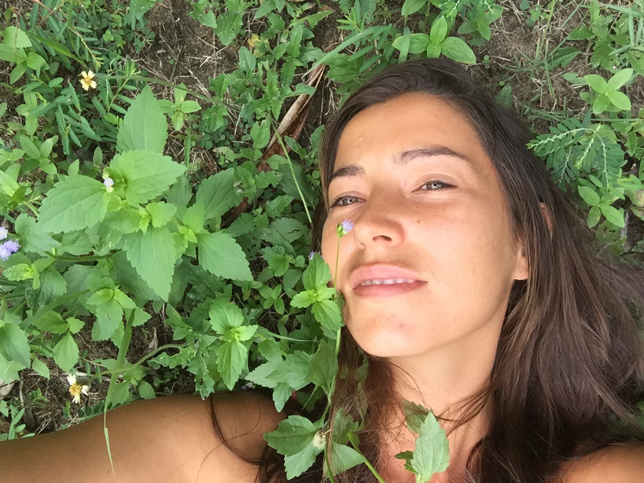 Miriam lying on the grass at her home.